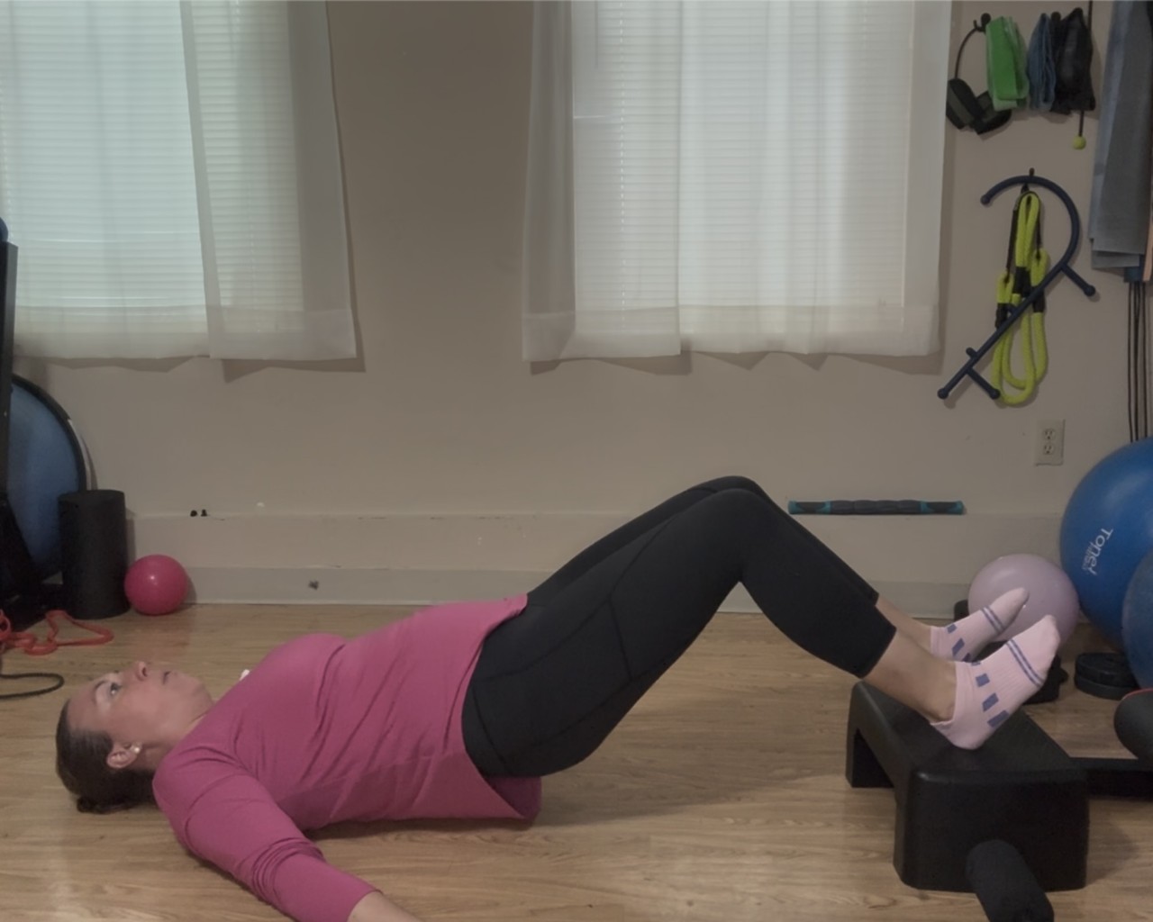 A women lying on her back performing a bridge
